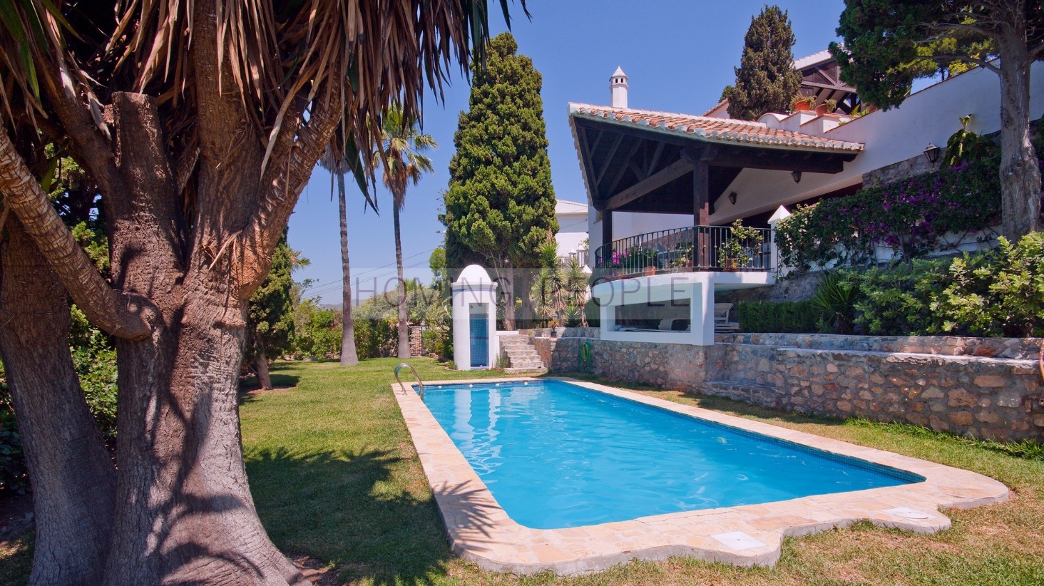 Immaculate villa featuring mature gardens with a pool and a guest house.