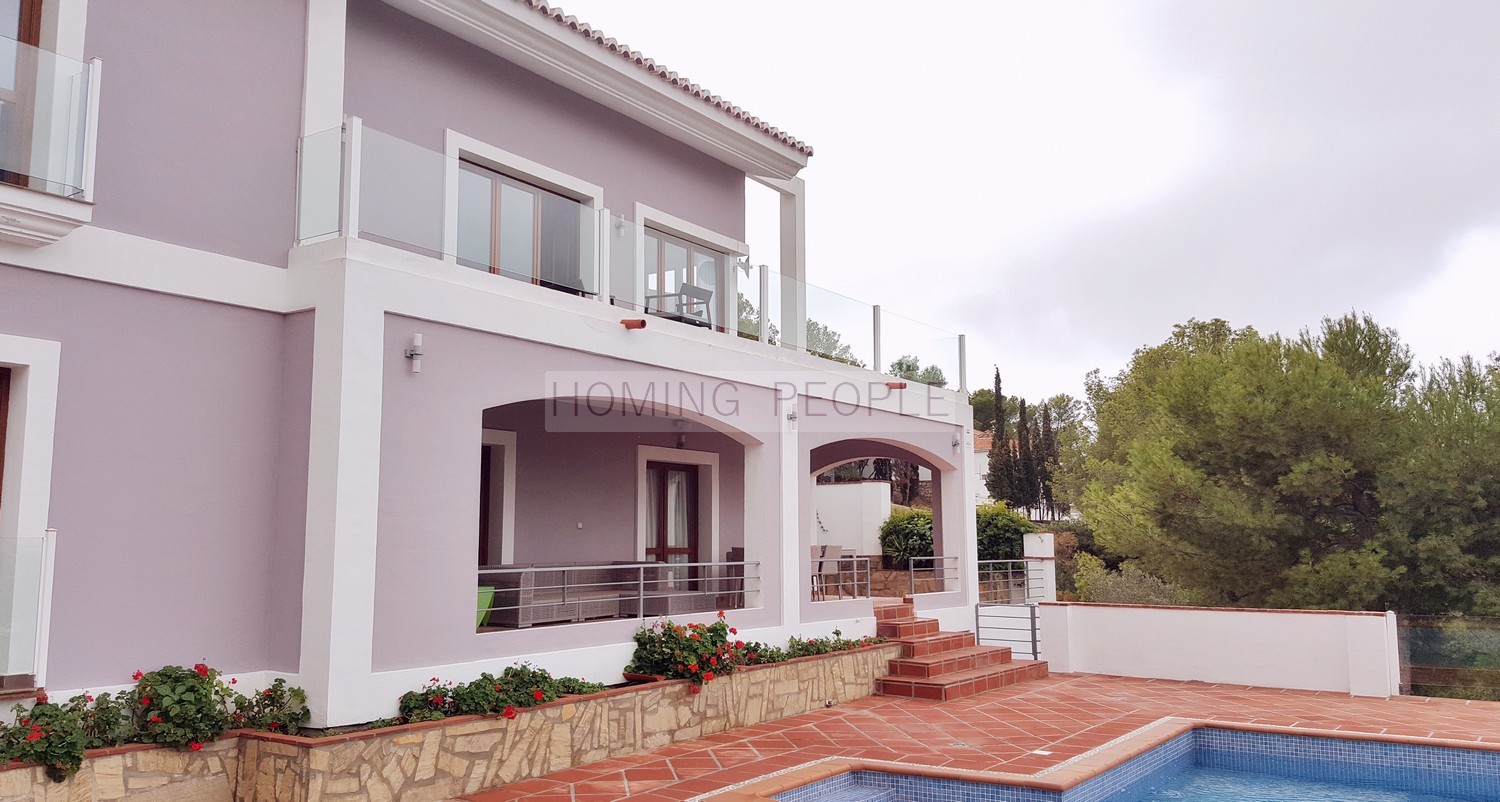Luxury neoclassical villa decorated modern and cheerful, in a natural Mediterranean setting